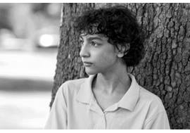 Preteen Boy Leaning on Tree