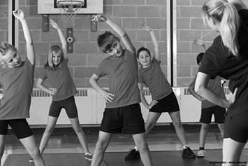 image of kids stretching in gym class