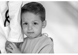 Young Boy Holding Physician Hand