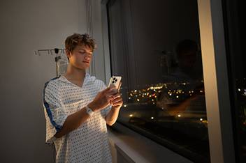 teen patient holding cell phone