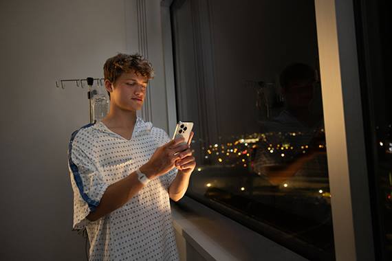 teen patient holding cell phone