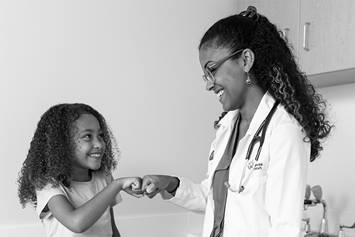 Doctor and patient fist bumping