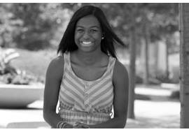 Teenage Girl Smiling and Sitting Outside
